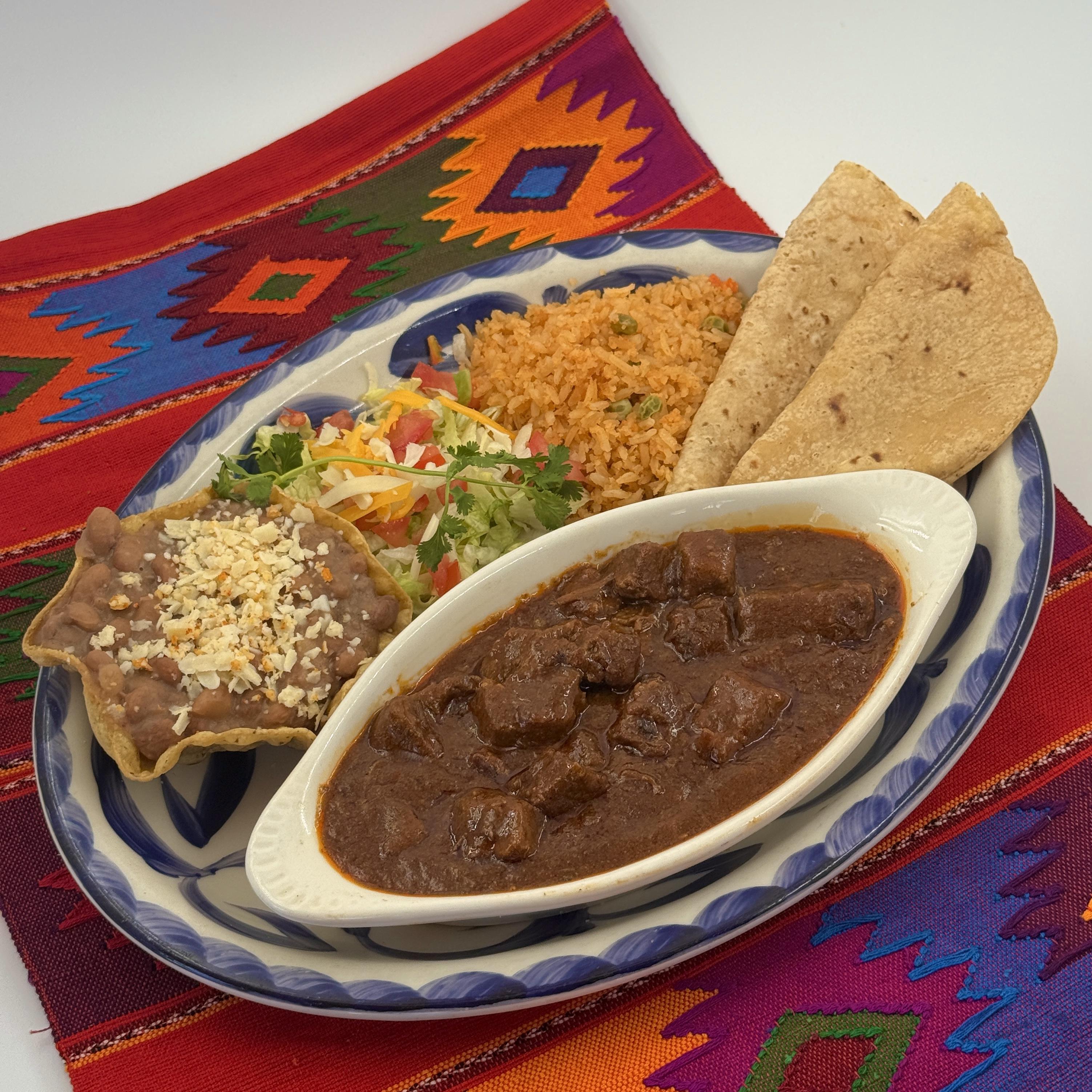 CHILE COLORADO, Tender cubed beef in our traditional red chile Colorado sauce. Served with Mexican rice and refried beans. Handmade tortillas upon request.CHILE COLORADO