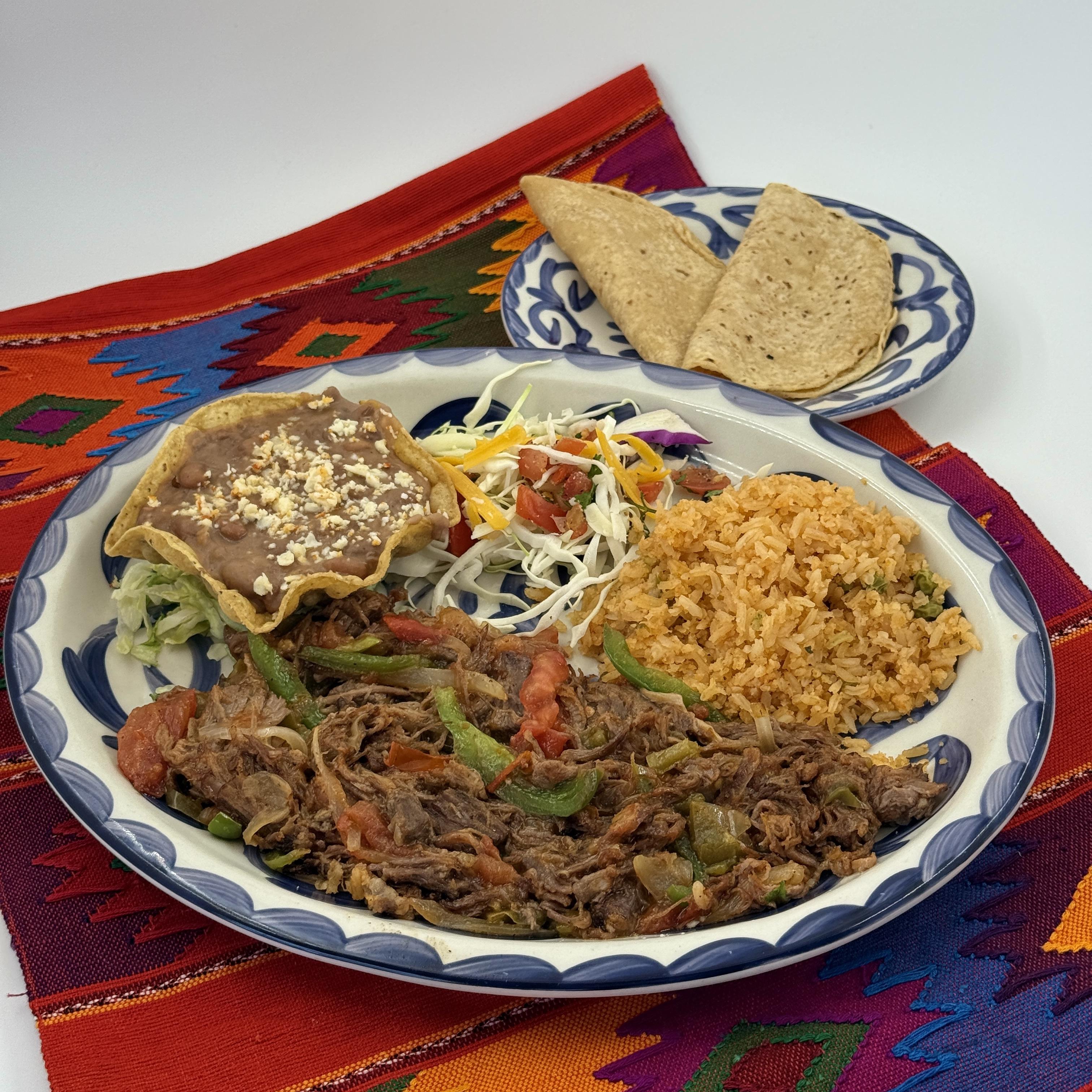 ROPA VIEJA, Shredded beef sauteed with peppers, onions and tomatoes