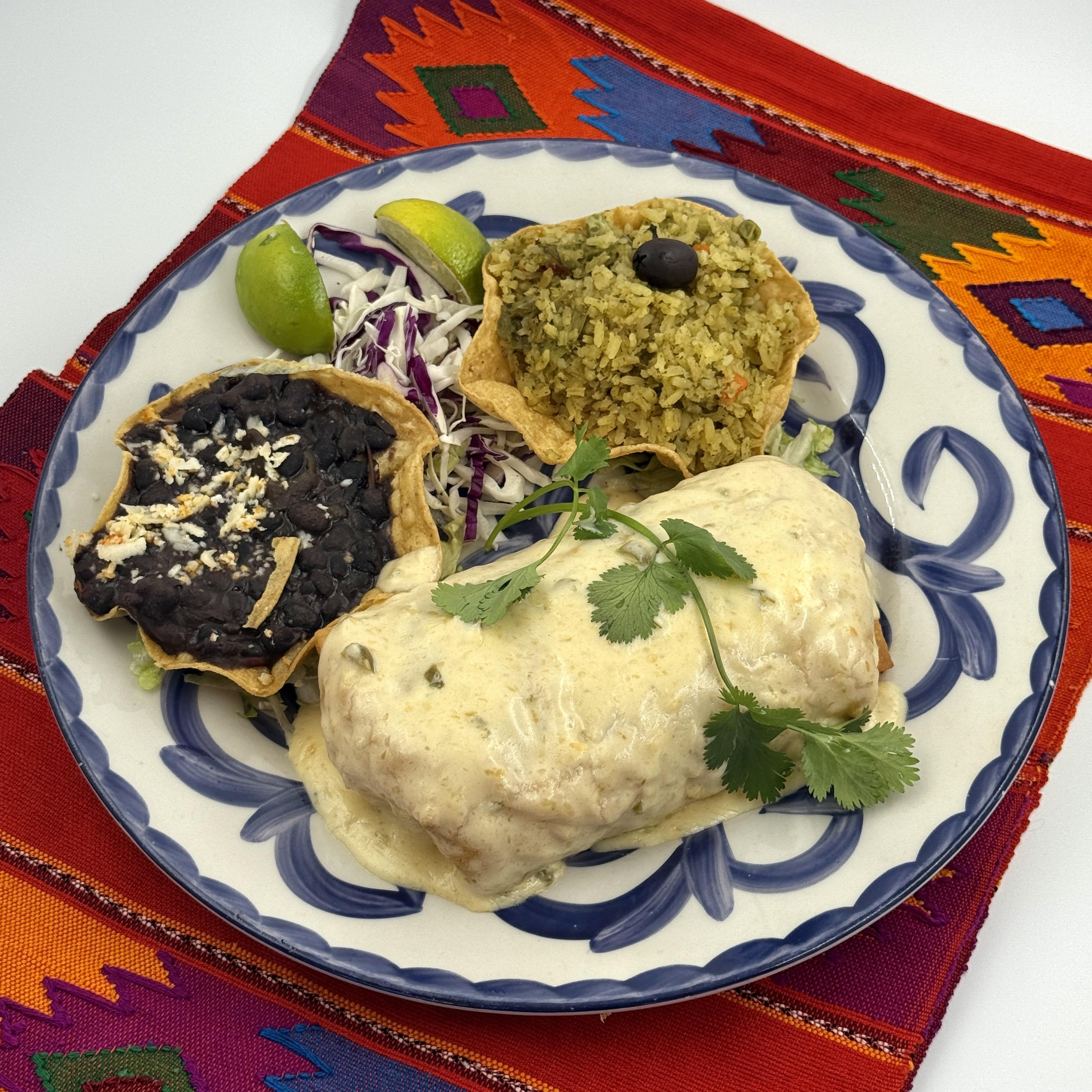 Seafood Chimichanga Pescado blanco, shrimp, grilled vegetables and rice, in a flour tortilla, deep-fried. Topped with cheese, jalape˜no cheese sauce and served with black beans.