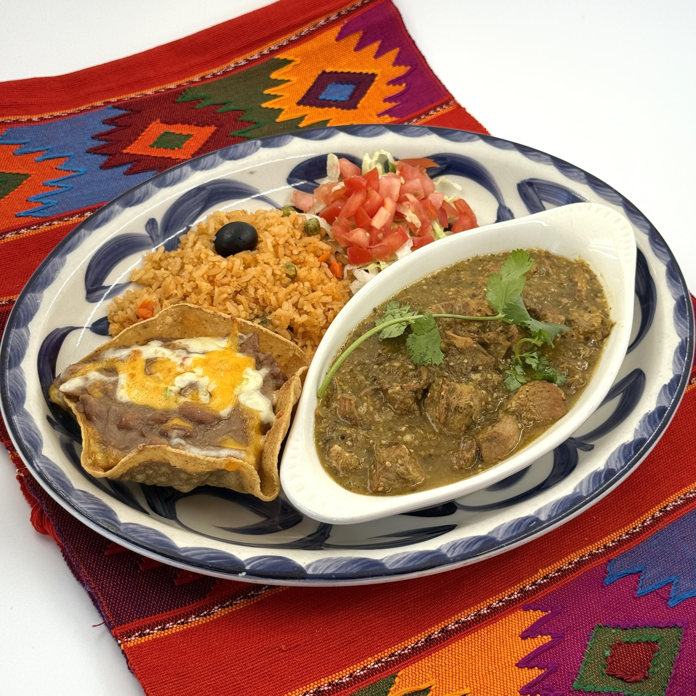 CHILE VERDE Tender seasoned pork prepared in a mild chile verde sauce. Served with rice and beans. Handmade tortillas upon request