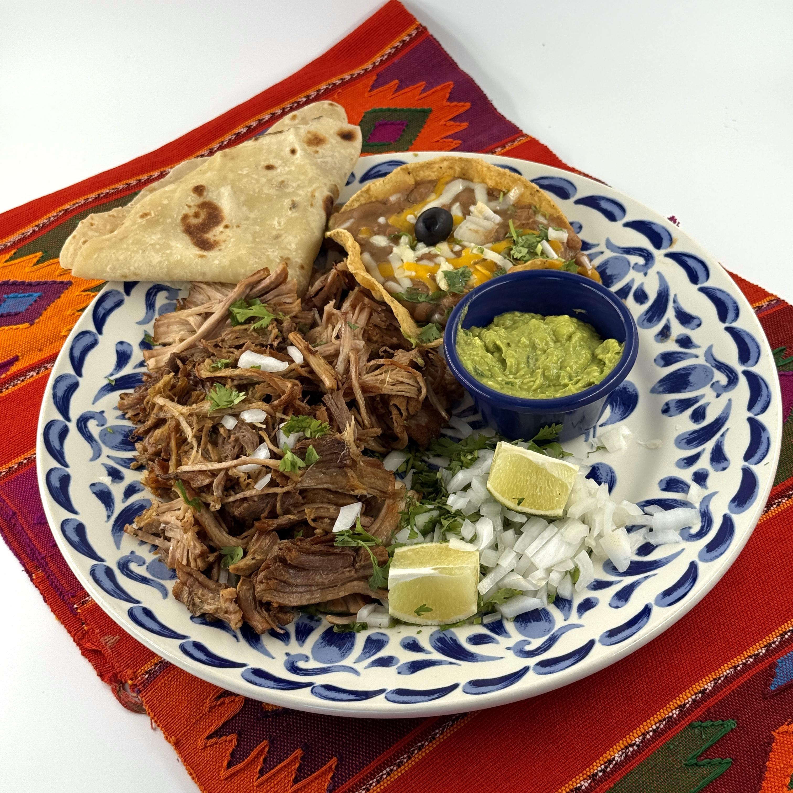 CARNITAS, Great to wrap in hot tortillas! Pork served in the traditional Mexican style, with Pico beans, guacamole, salsa fresca, onions and cilantro.