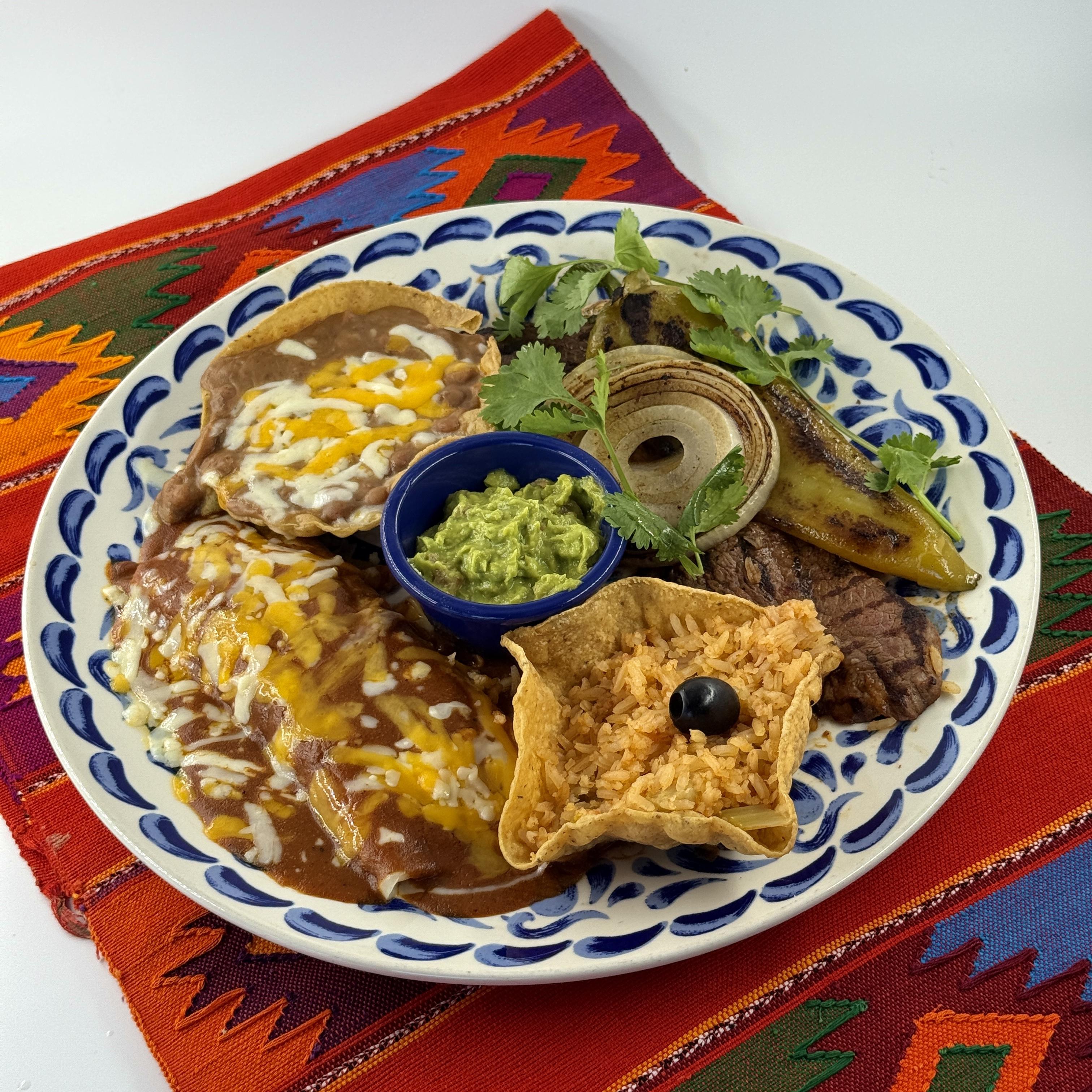 CARNE ASADA TAMPIQUEÑA, Carne asada topped with grilled onions and Anaheim chile, an enchilada with melted cheese, chopped onions and olives, served with Mexican rice, beans, guacamoleand hot tortillas.