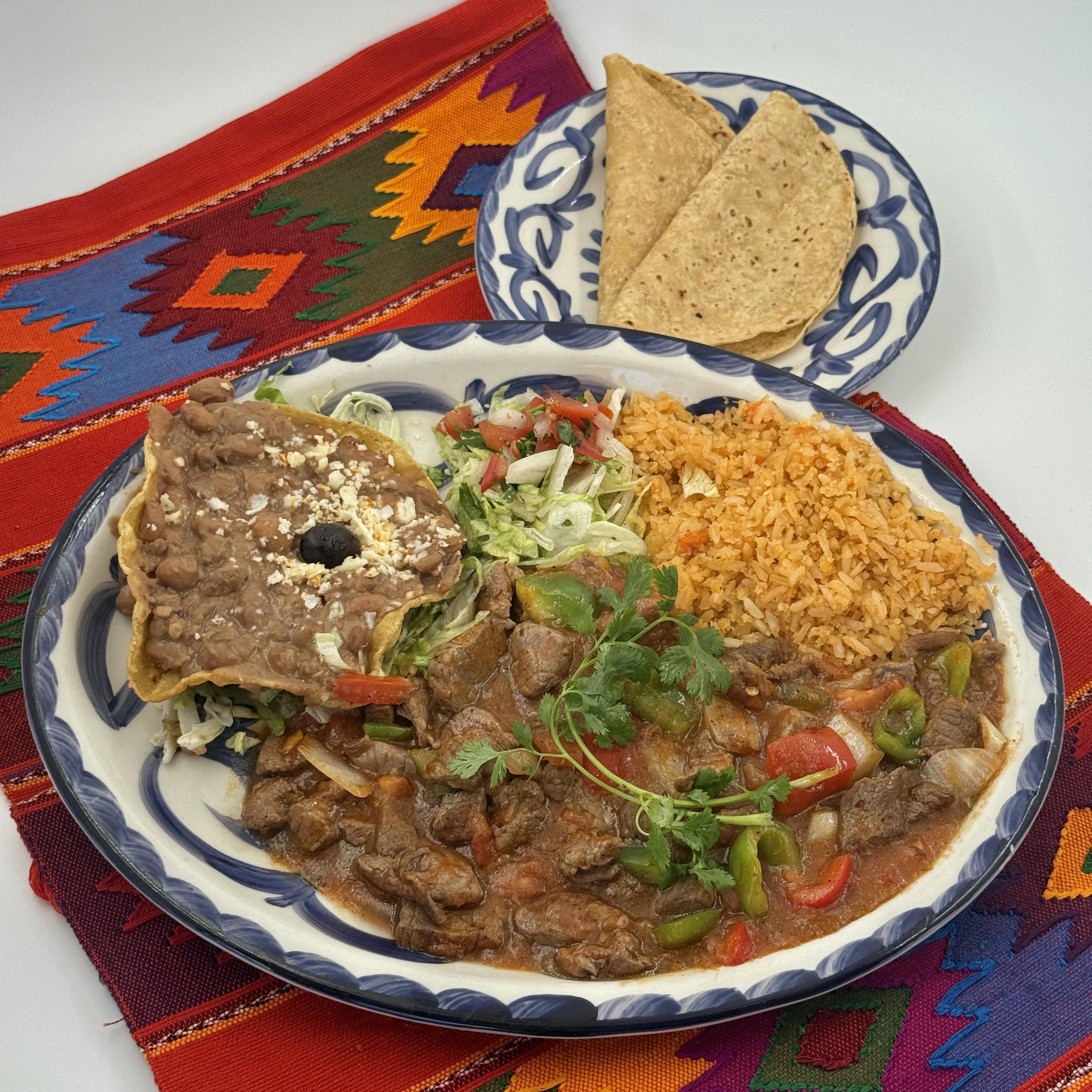 STEAK PICADO California-style cubes of steak lightly sautéed with bell peppers and onions in our special espan˜ola sauce. Served with rice and beans. Handmade tortillas upon request.