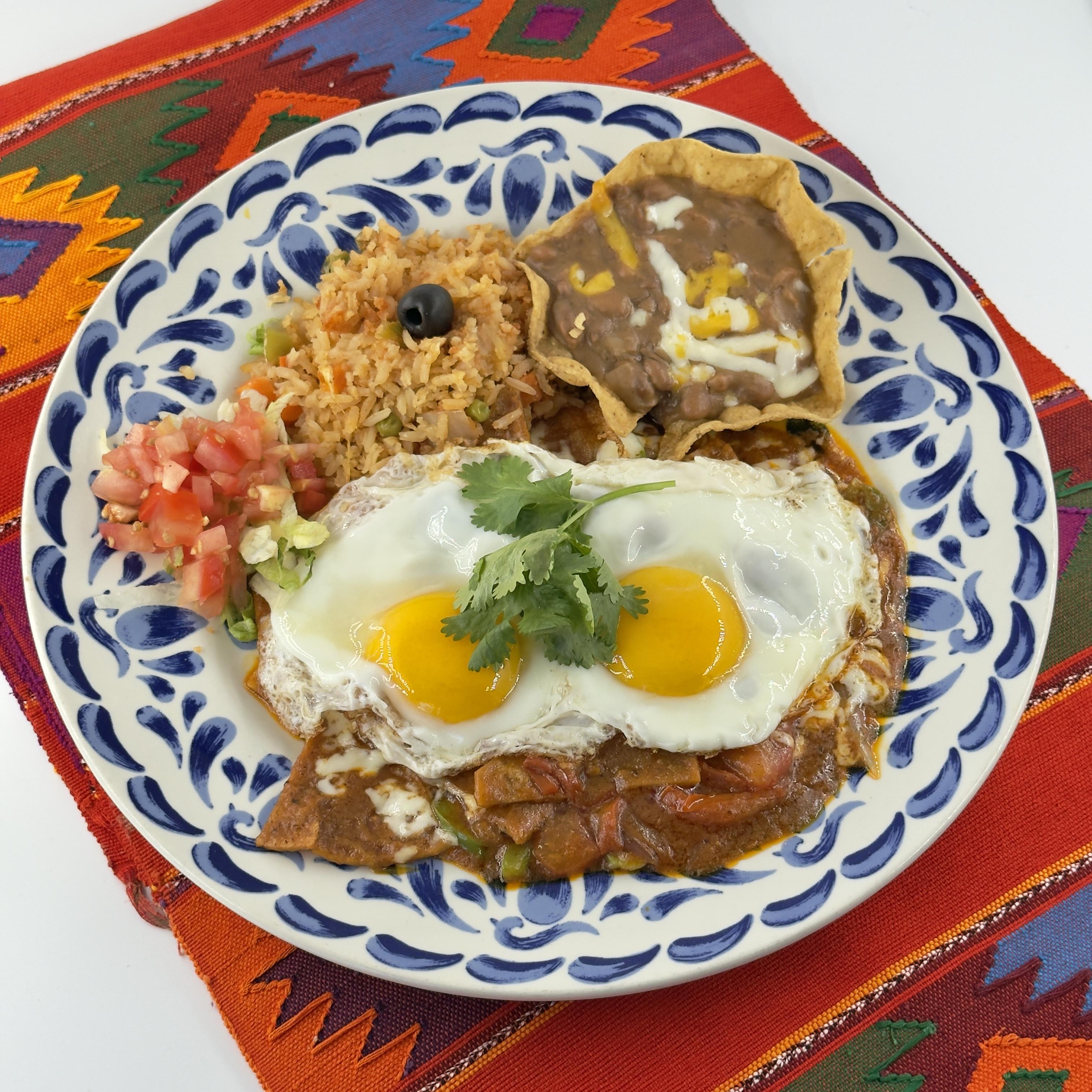 Chilaquiles Con Huevo An authentic Mexican breakfast. Corn Tortillas that we lightly fry until they're golden. Topped with Spicy Salsa, melted queso, and two perfectly cooked eggs.