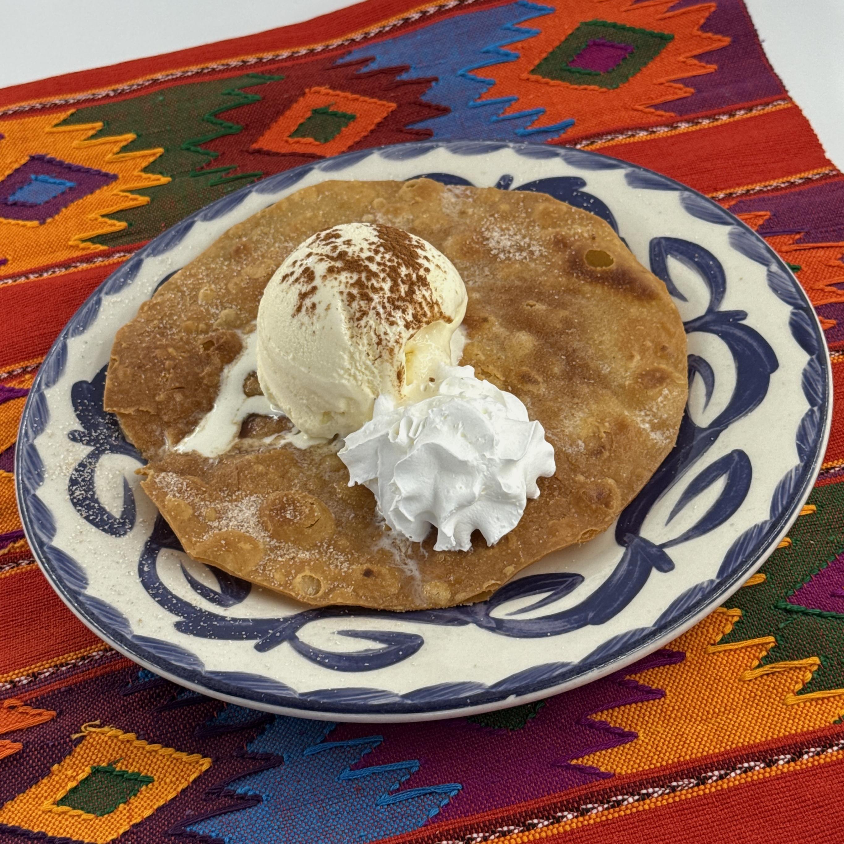 Bunuelo, Crispy rounds of fried pastry sprinkled with cinnamon sugar and topped with vanilla ice cream