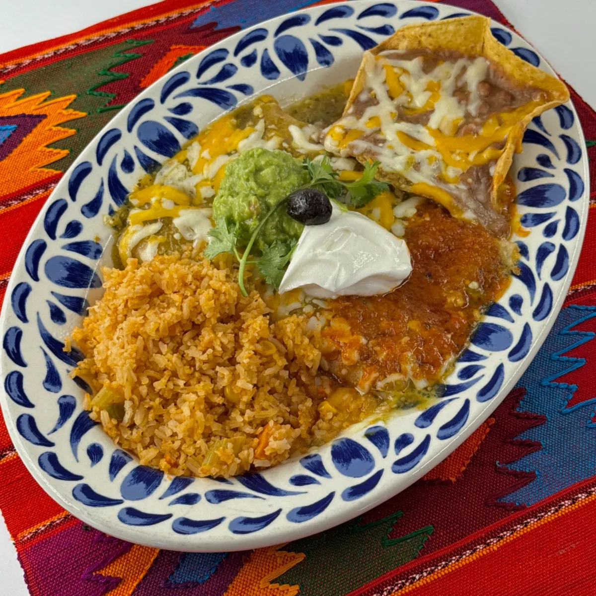 Muchisimos Taquitos, Traditional shredded beef or chicken rolled tacos topped with melted cheese. These taquitos are served with a side of zesty salsa, making them an irresistible favorite for everyone at the table.