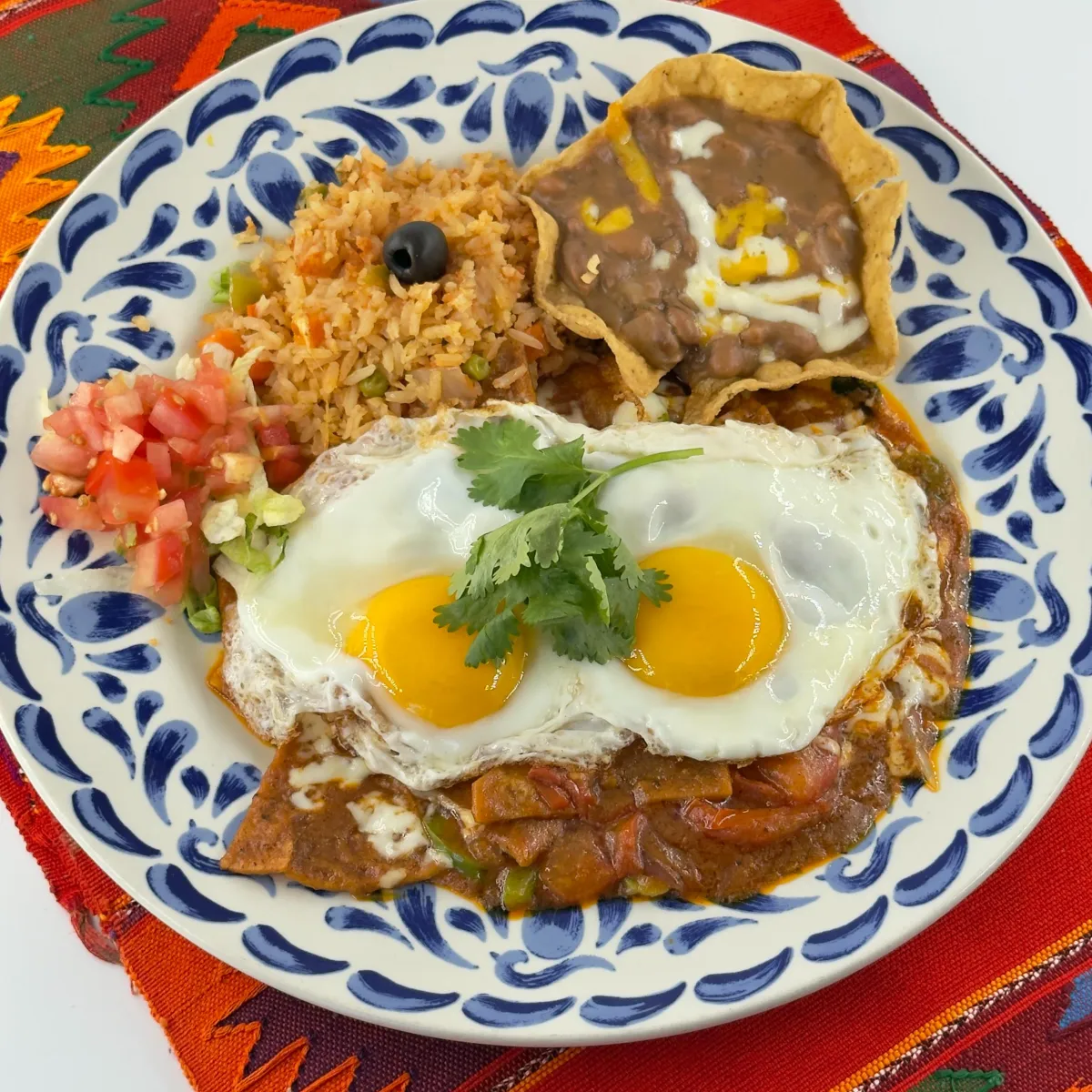 Huevos rancheros with two sunny-side-up eggs, rice, beans and tortillas