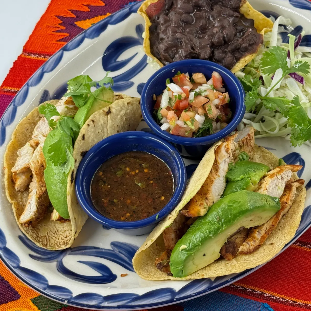 Grilled chicken and avocado soft tacos with salsa and pico de gallo