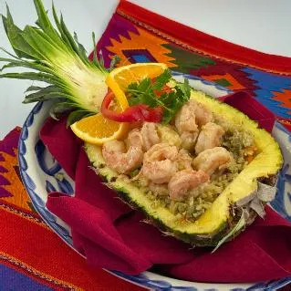 Shrimp served in a pineapple half with orange slices