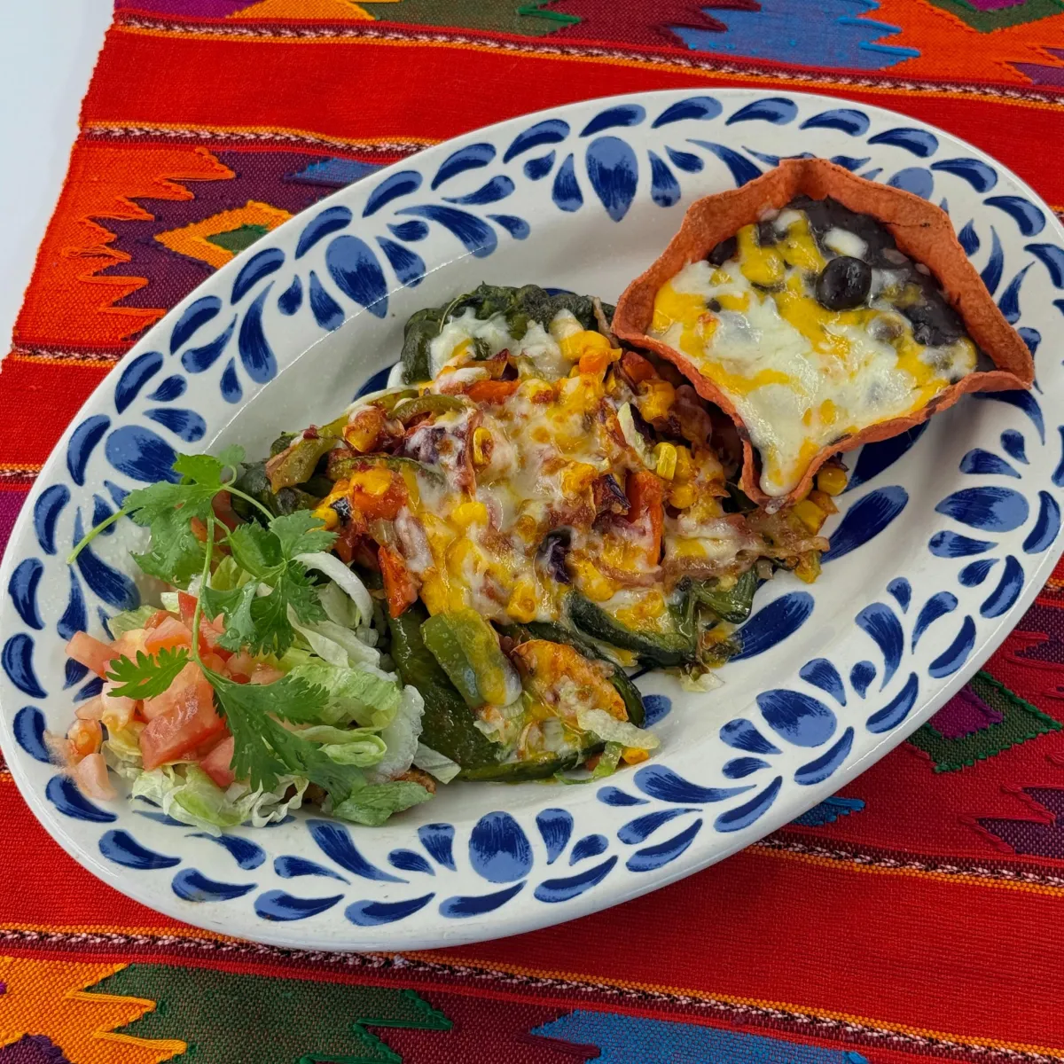Casa de Pico chile poblano fresco vegetarian plate with cheese-topped vegetables, black beans and side salad