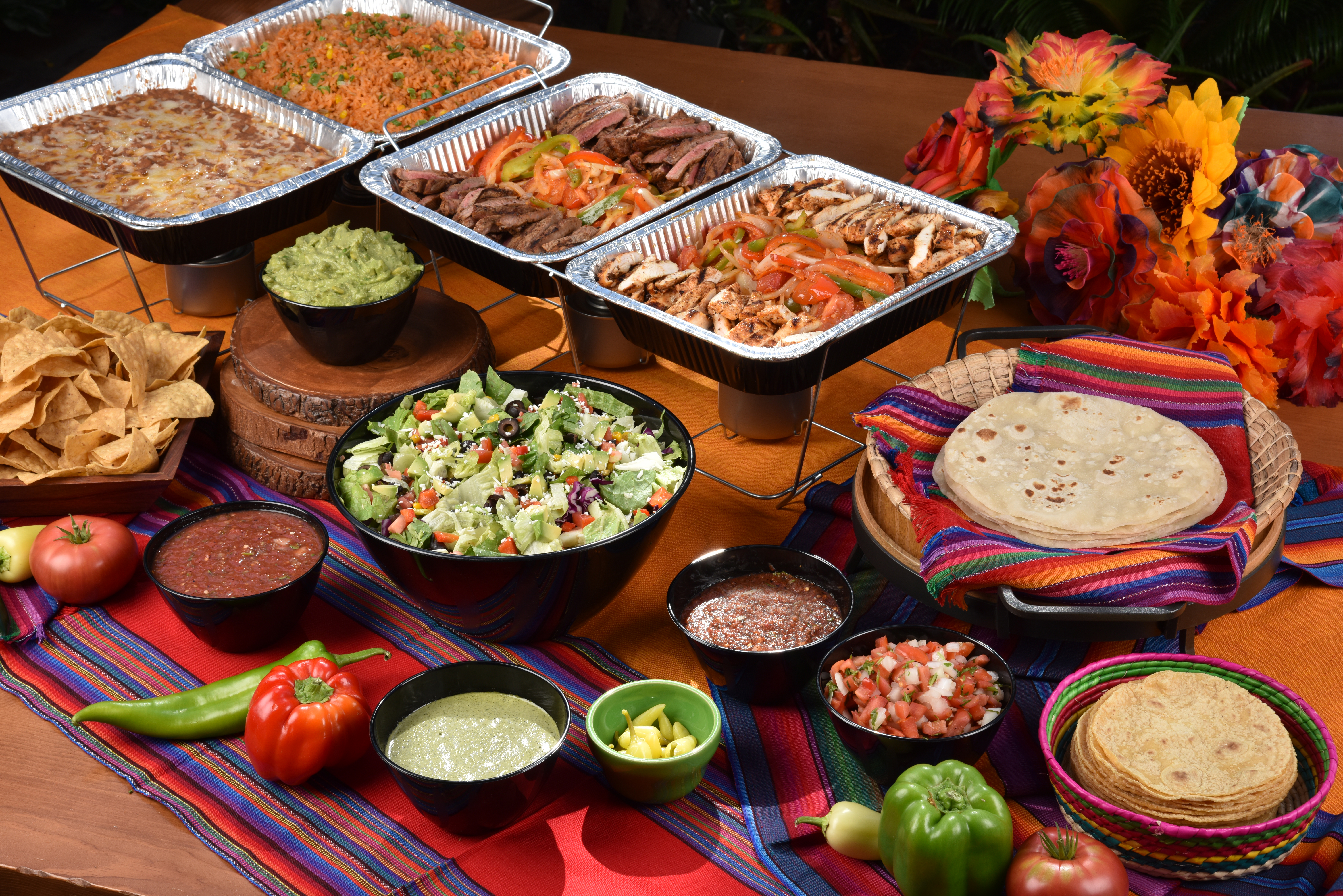 Fiesta Express Fajita Meal spread with grilled meats, rice, beans, tortillas, guacamole and salsas