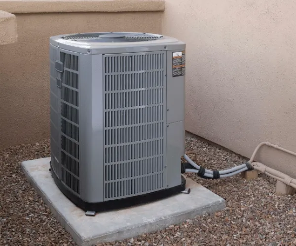 HVAC technician installing a new high-efficiency air conditioner in a Phoenix home