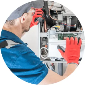 HVAC maintenance technician inspecting system for seasonal tune-up in Phoenix