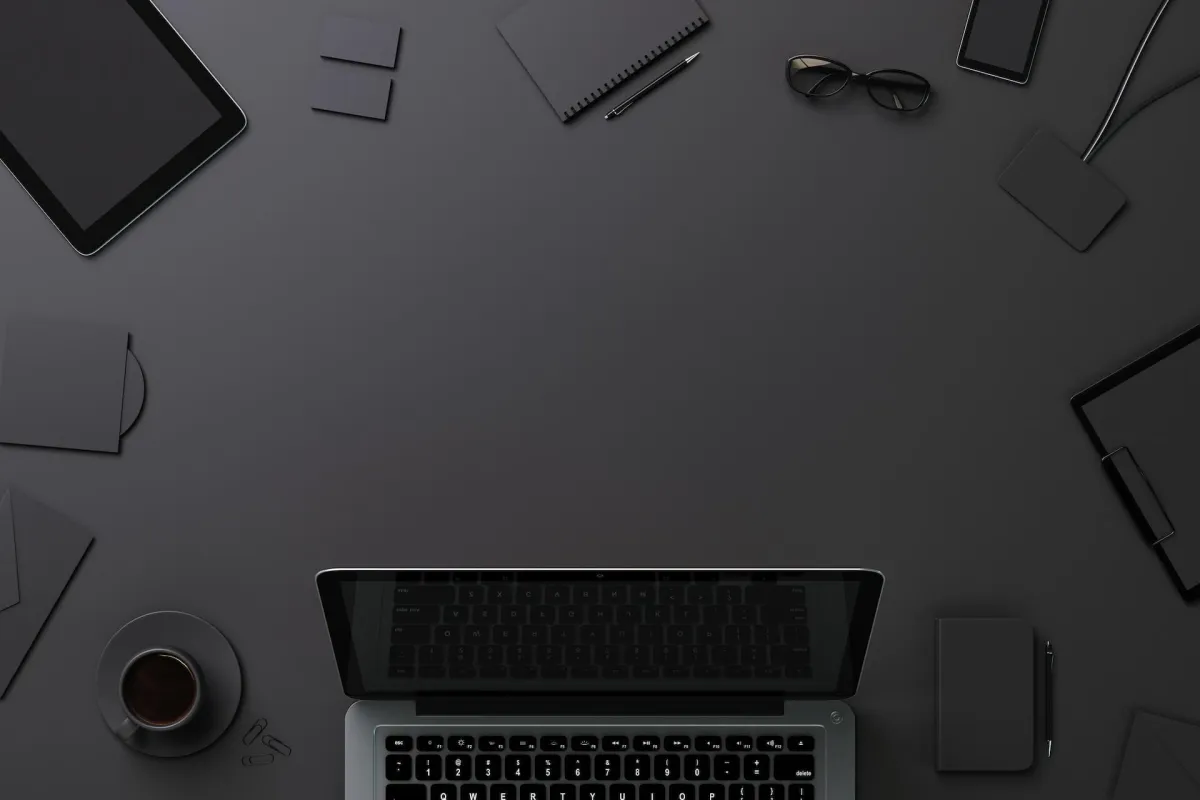 laptop on table with other devices