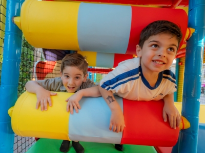 Children racing the the Playhouse on Wheels mobile playground obstacles. 