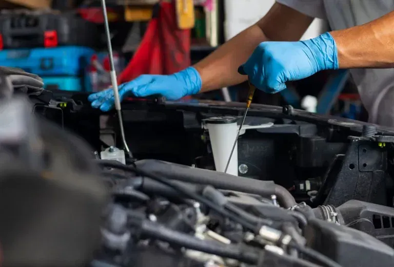 Technician performing RV winterizing service to protect plumbing and water systems in St Charles Missouri