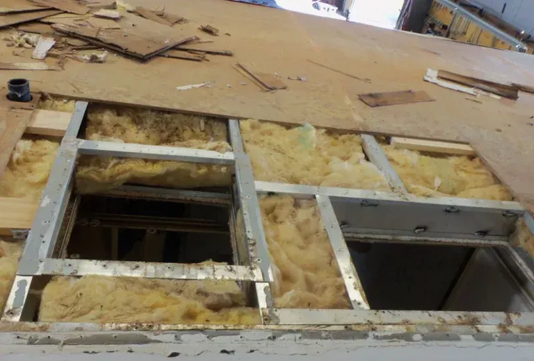 Technician performing moderate RV collision repair on motorhome body panel in St Charles Missouri