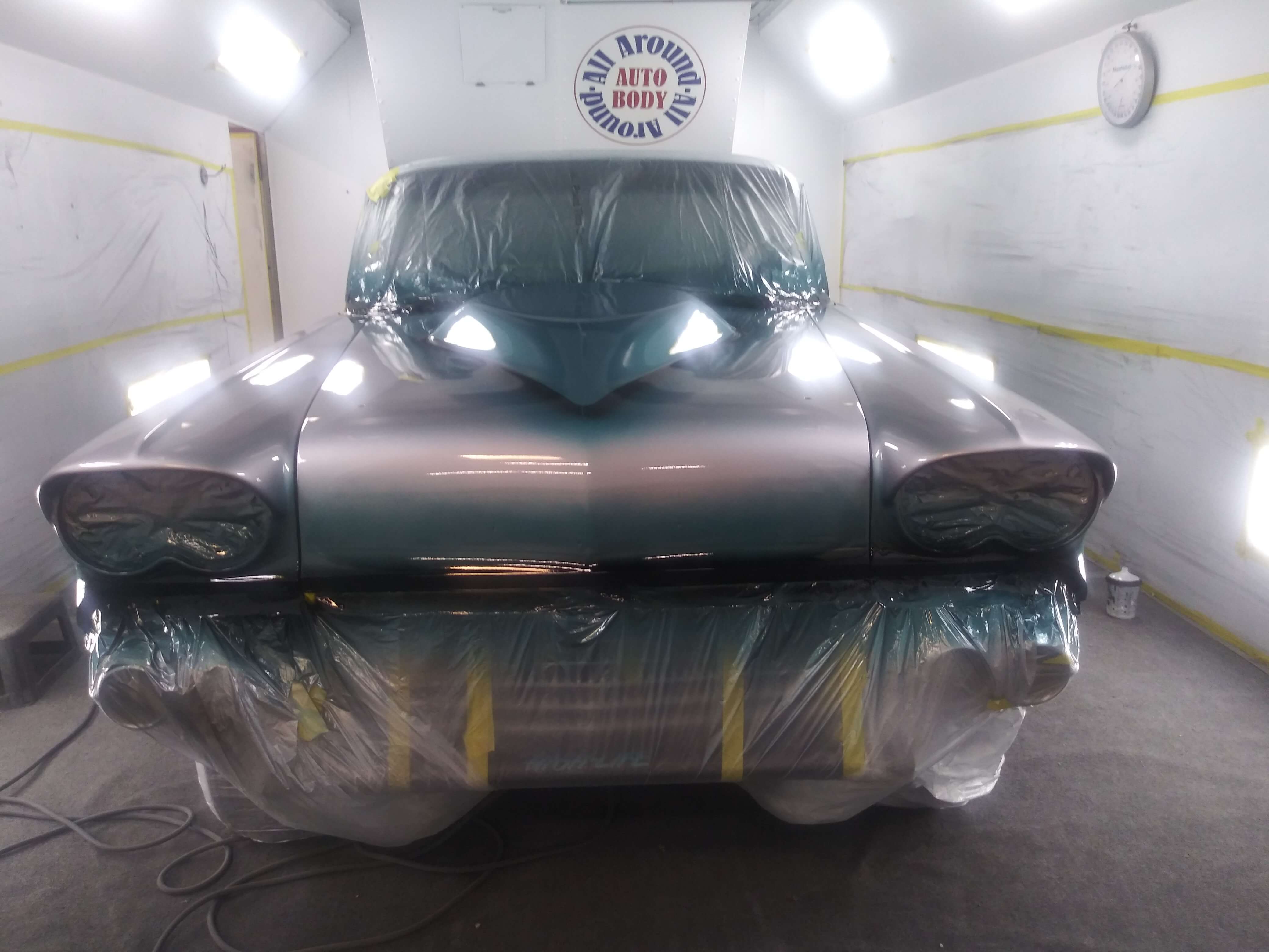 Classic car getting painted in the spray booth.