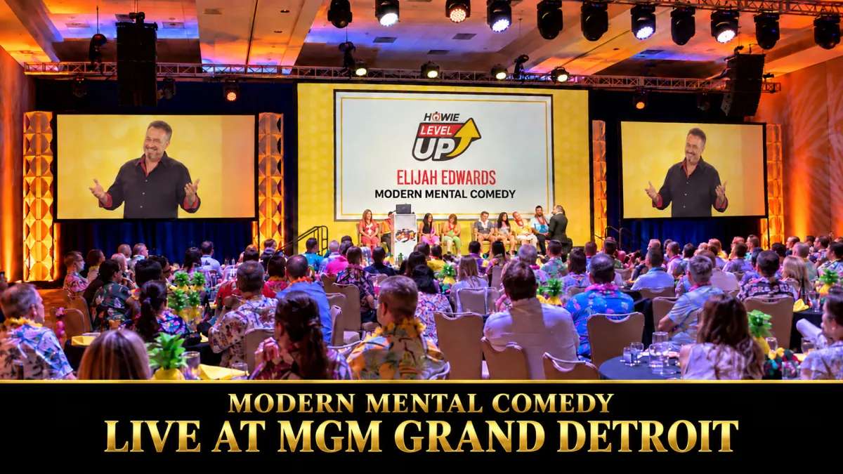 Elijah Edwards presenting Modern Mental Comedy before a conference audience at MGM Grand Detroit with his live image displayed across the stage screens.