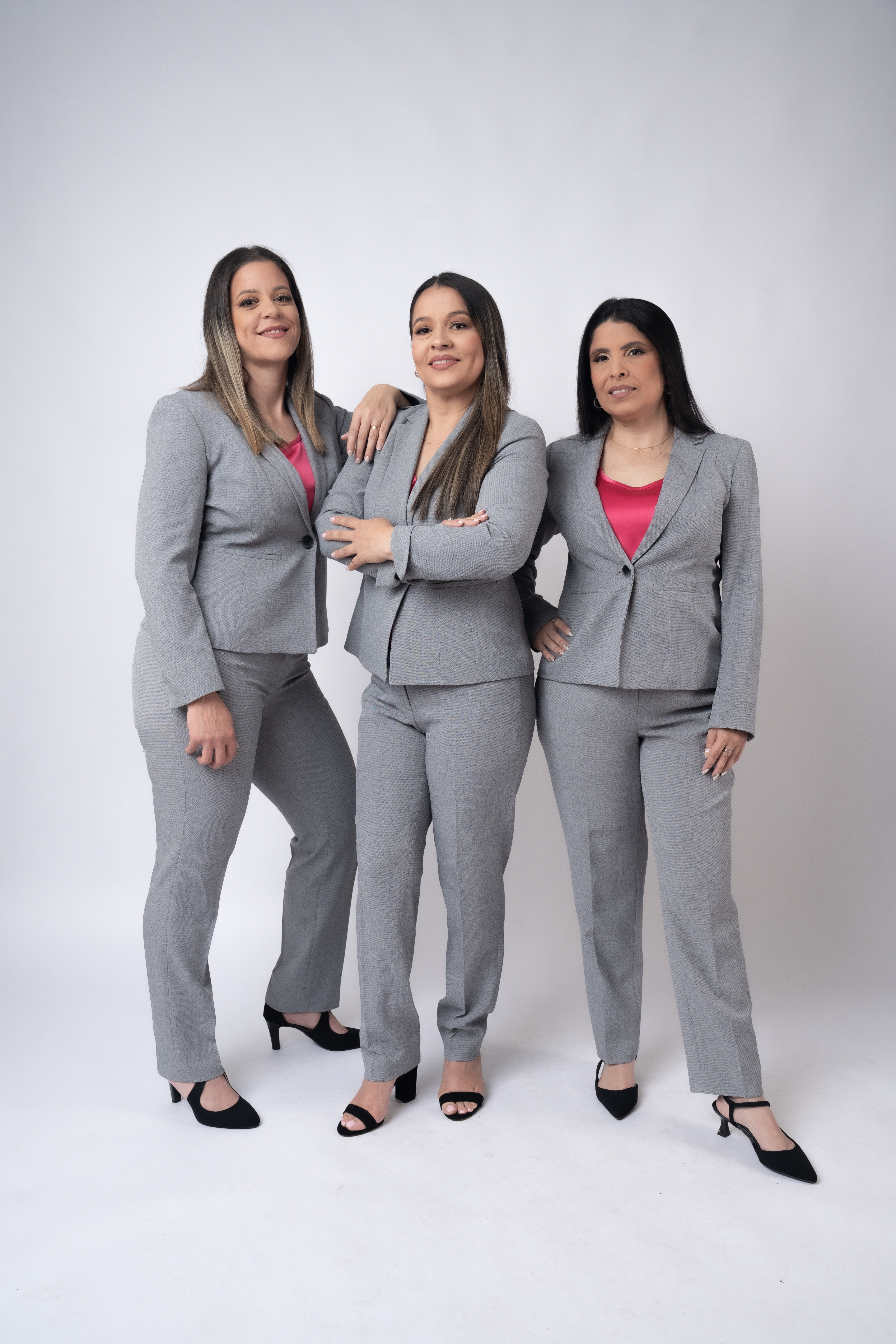 A diverse team of tax professionals in a modern office, smiling and collaborating over financial documents, with a digital tablet and calculator on the table. The background features large windows and city views, conveying trust and expertise.