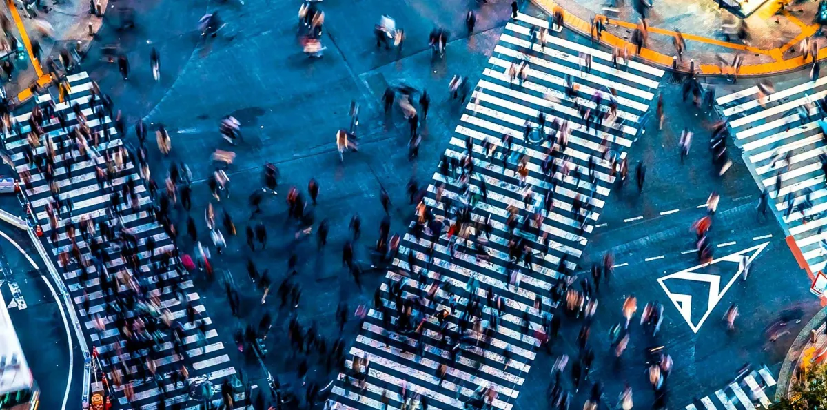Aerial view of city streets with pedestrians crossing
