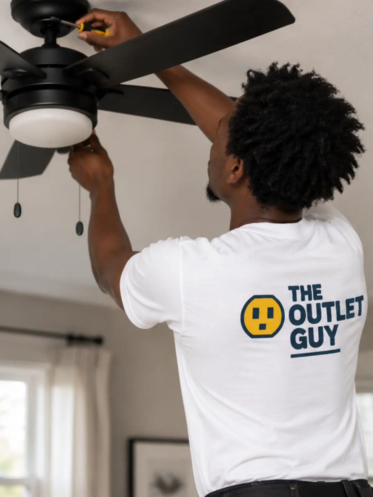 Electrician working on a wall outlet