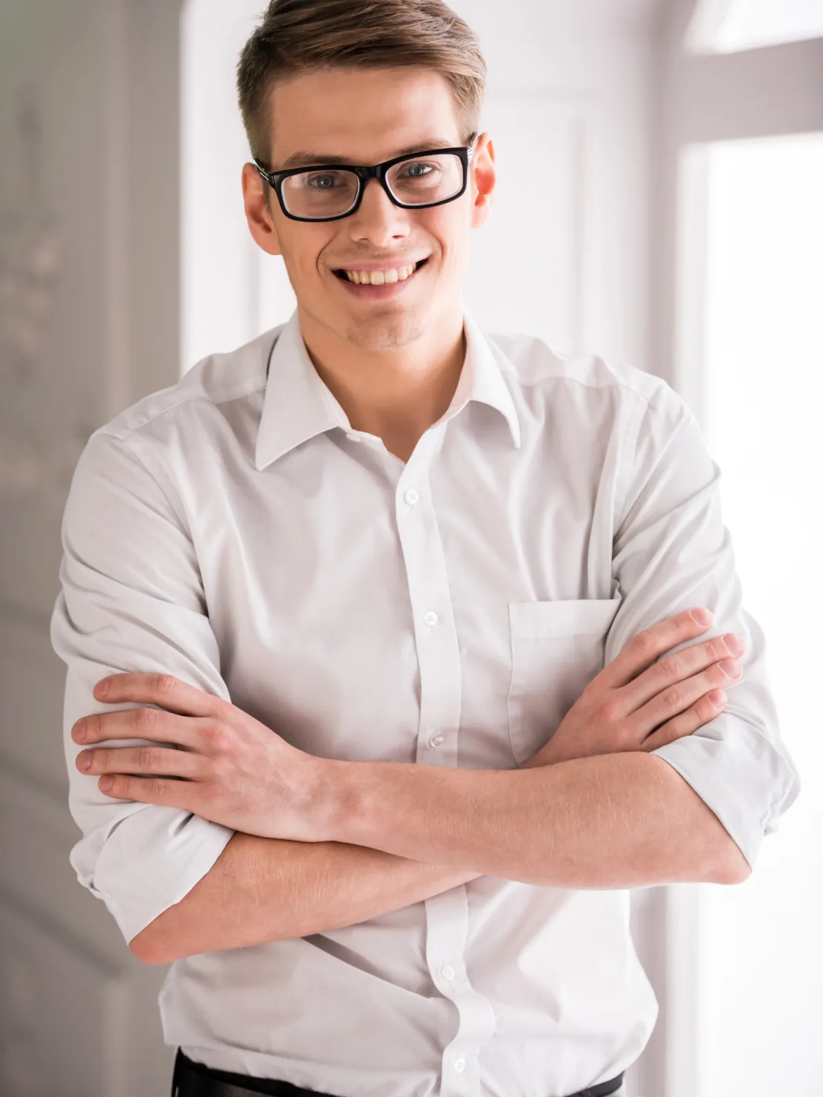 A music teacher, sits beside a grand piano holding a music sheet, focused and ready for the lesson. The room is bright and inviting, with natural light highlighting the elegant piano. Located in Farmington , Utah.
