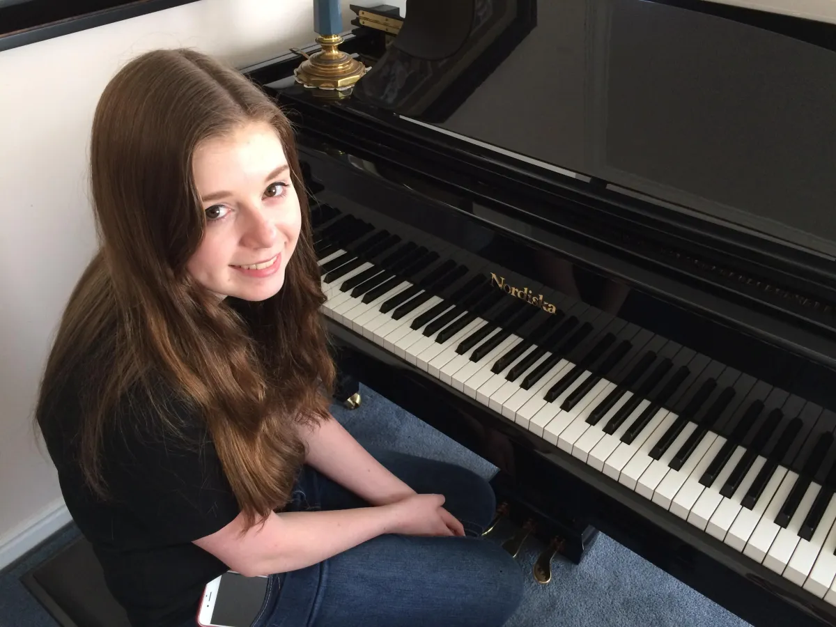 Teen piano student at a Nordiska upright piano during a private lesson at a Farmington, Utah music school.