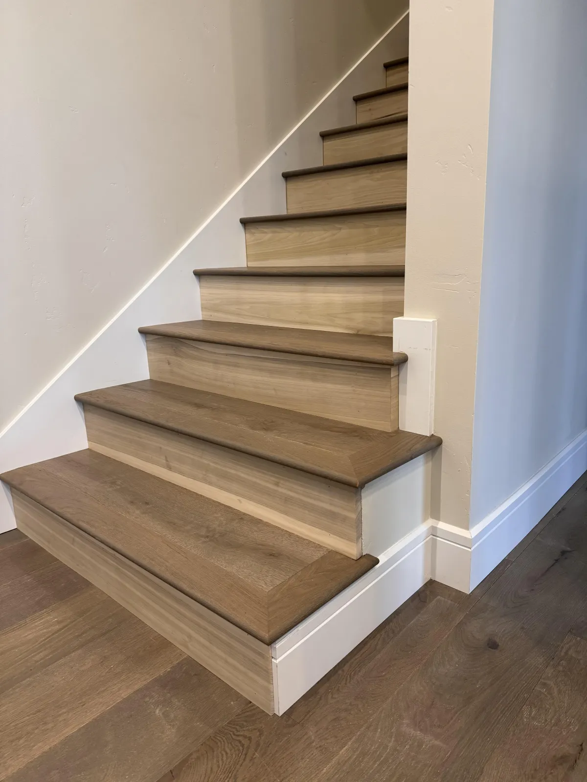 Dark wood staircase with white risers