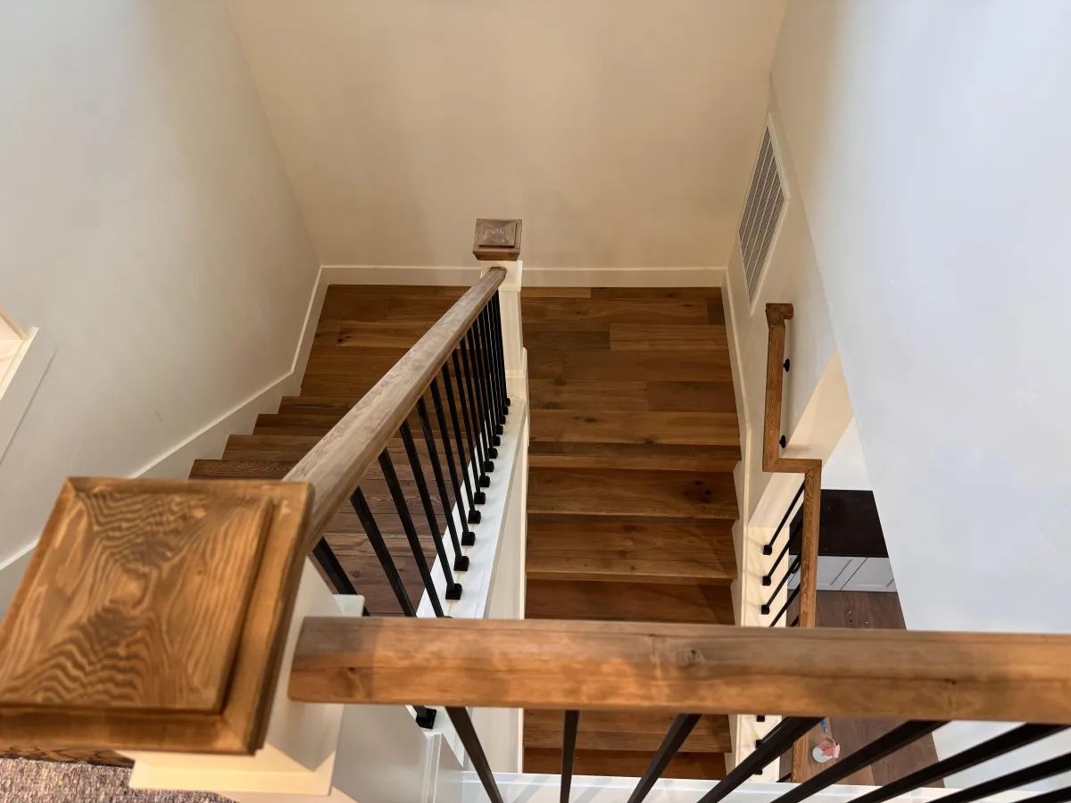 Open staircase near kitchen cabinetry