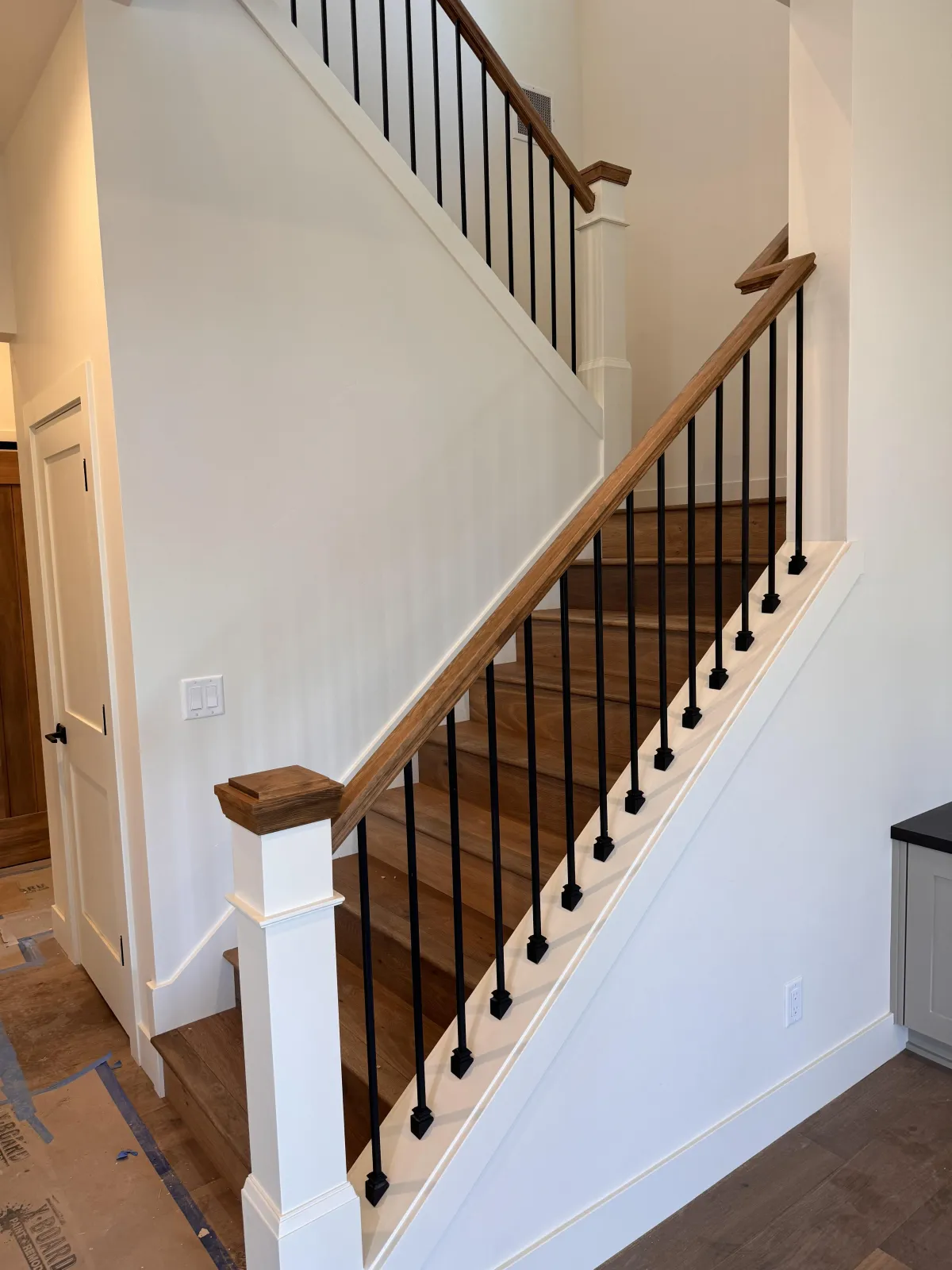 Wood staircase with white railing spindles