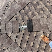 Missing shingle from wind damage caused by a recent storm.