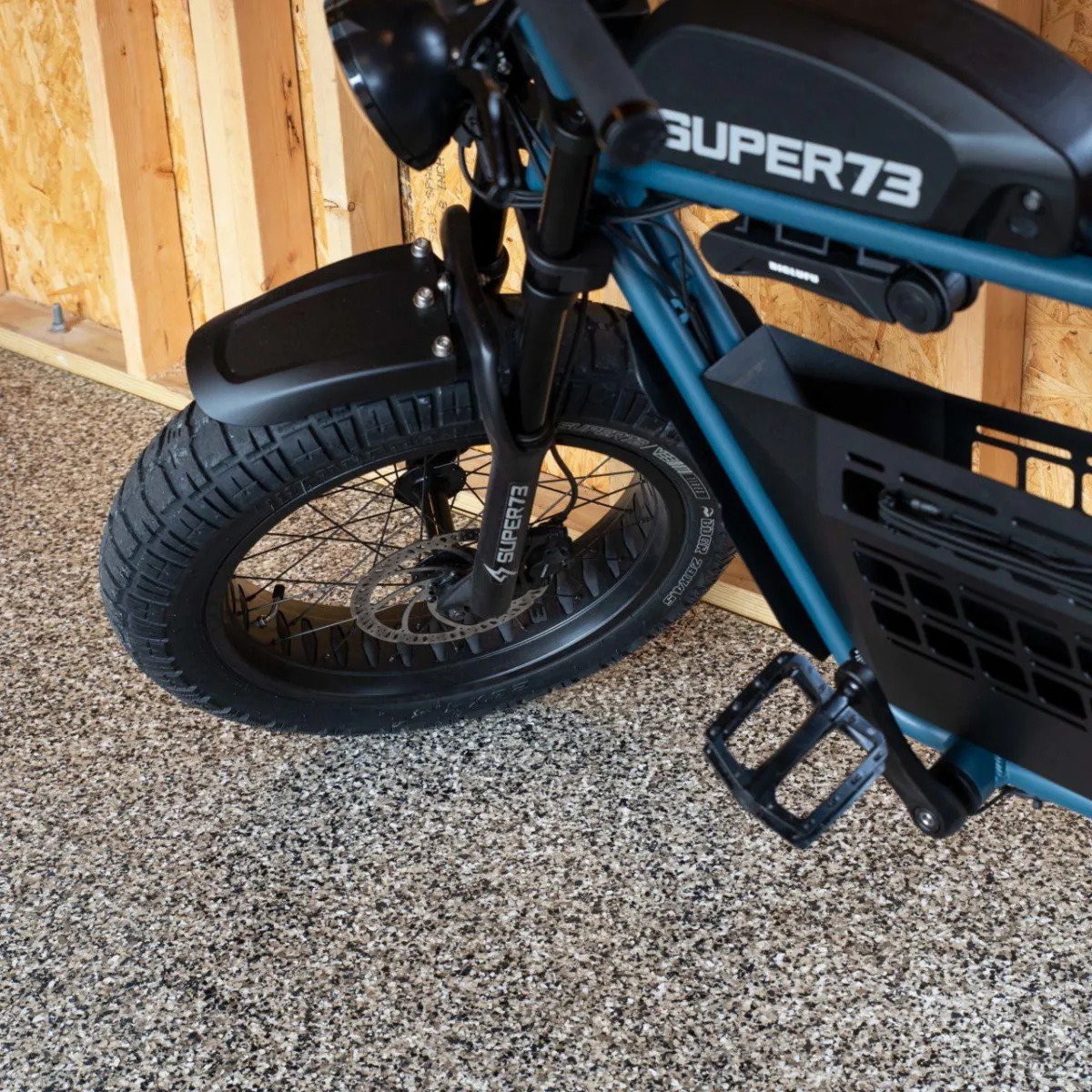 "Motorbike parked on garage floor with full chip coating, highlighting scratch-resistant and durable finish