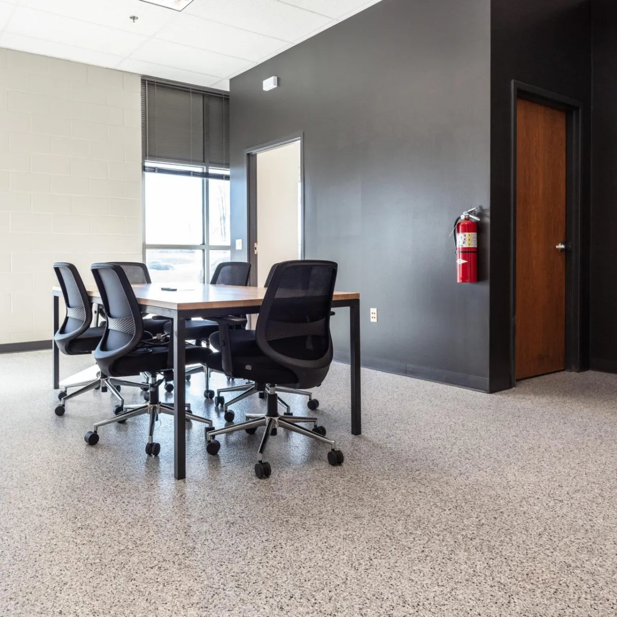 Office space with full chip floor coating, showing versatility of garage floor coatings in commercial settings