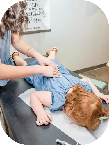 Dr. Haley gently adjusting toddler