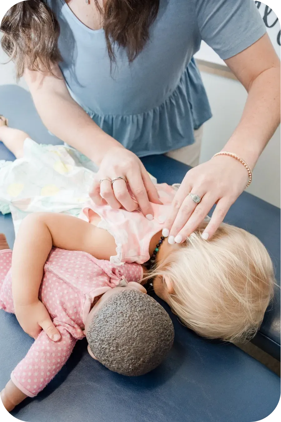 Dr. Haley gently adjusting spine of toddler