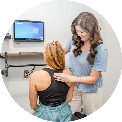 Dr. Haley Turpin, adjusting an expecting mother