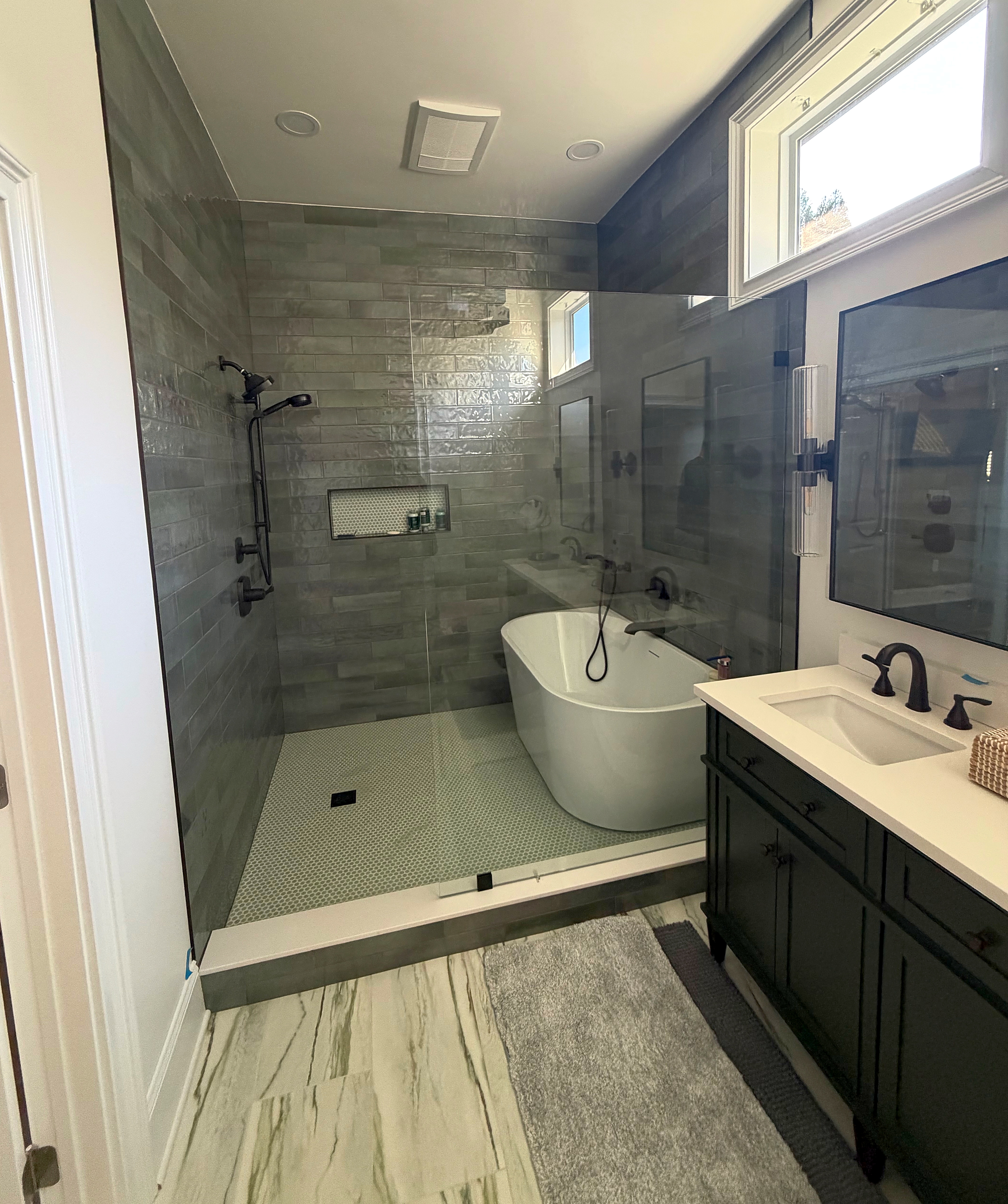 Premium primary bathroom renovation featuring custom shower and luxury vanity