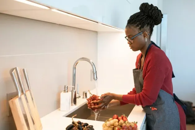 A senior care professional prepares food as part of er homemaker care responsibilities provided by Sumner In-home Care and Preferred Care at Home