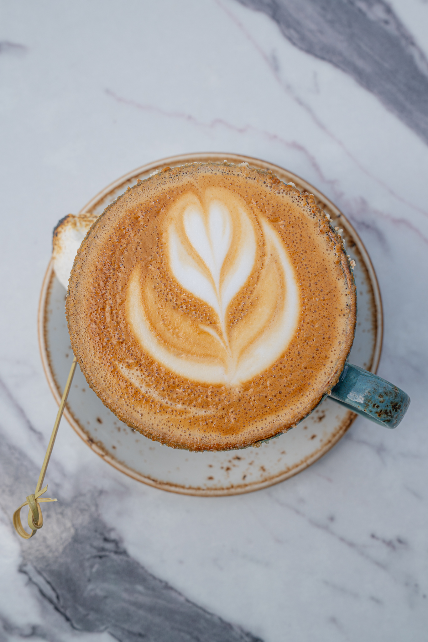 Latte with leaf art served at The Aussie Grind Provisions café in Farmers Branch, TX