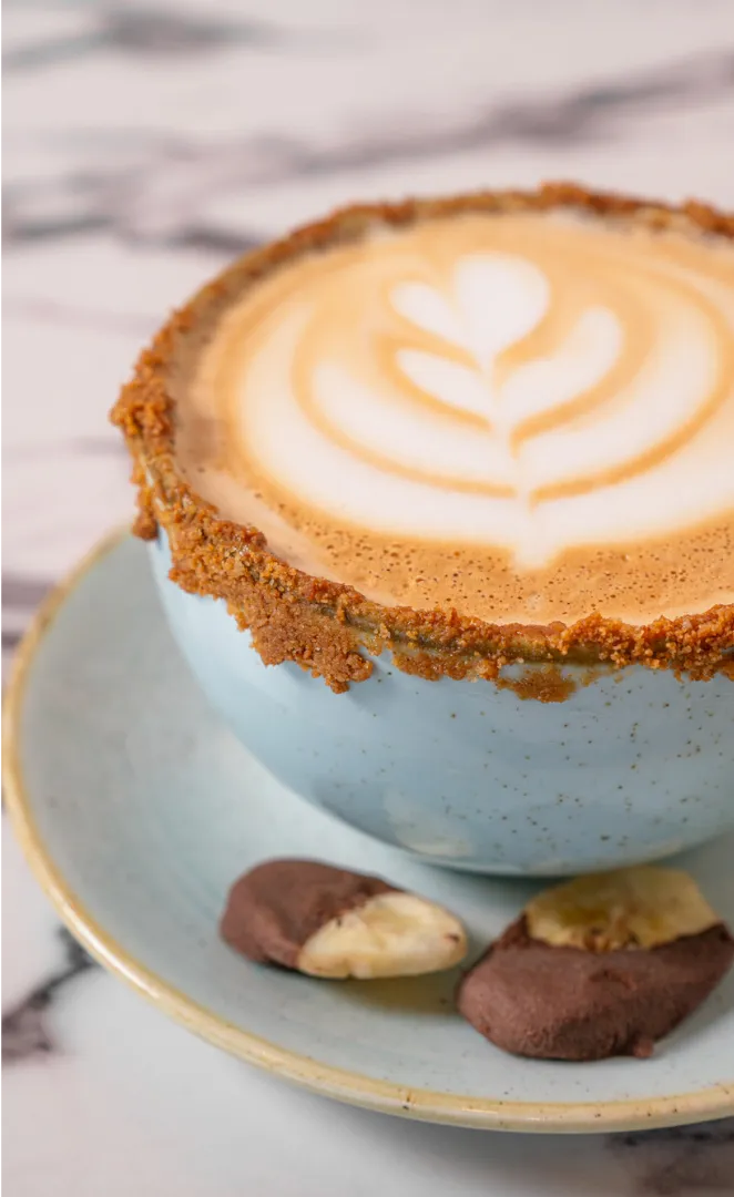 Espresso latte with leaf art crafted from in-house roasted beans at The Aussie Grind Roastery