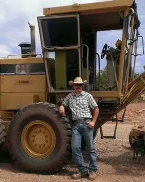 Aaron Solomon next to a tractor.