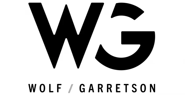 The stylized logo in two rows. "WG" on top with "WOLF / GARRETSON" below.