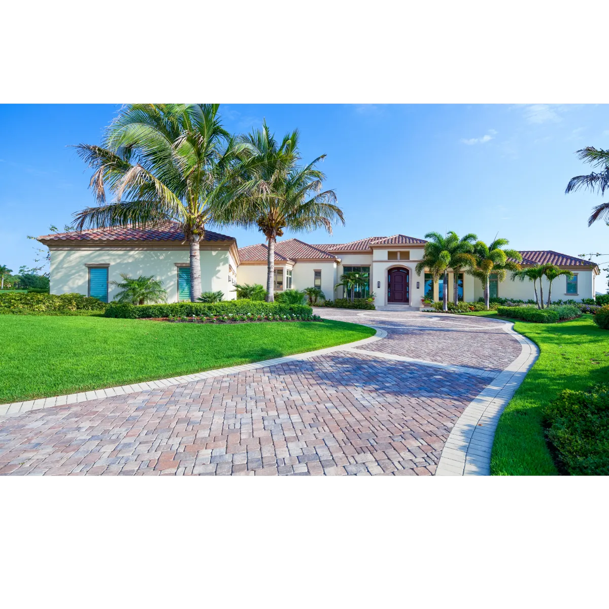 Florida house with long brick driveway 5 palm trees and tan stucco