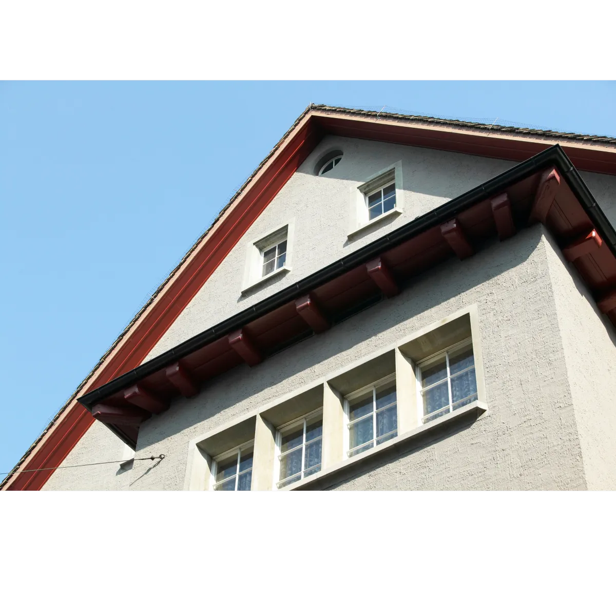 house with 6 windows and beige stucco 