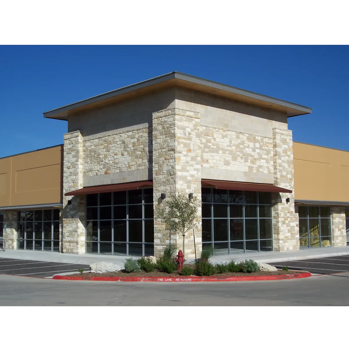 commercial building with brick and tan stucco