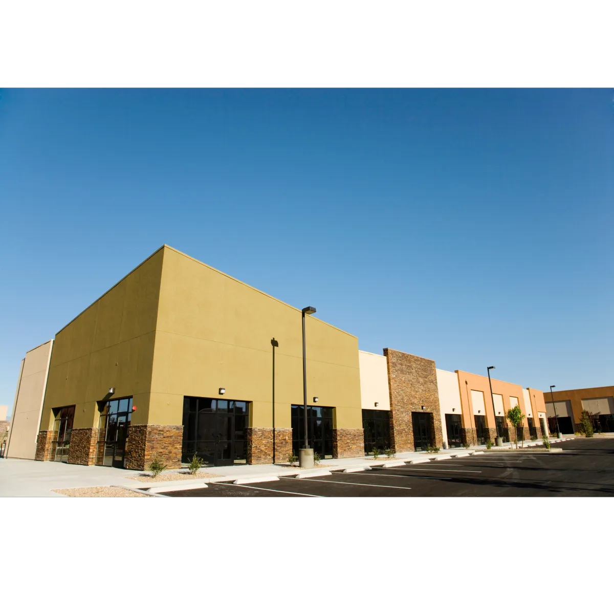 commericial buildings with tan pink, and orange stucco with brick siding