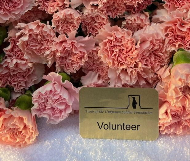 volunteer badge in front of the flowers