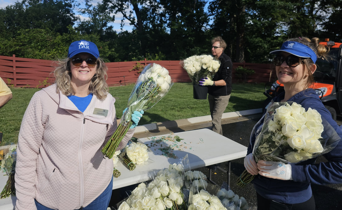 Volunteers holding flower at the Flowers of Remembrance