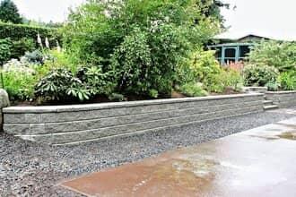 Curved stone block landscape retaining wall on golf course